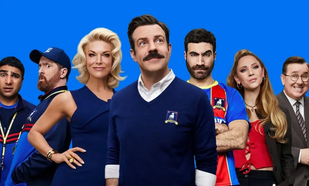 Personajes de Ted Lasso en fondo azul, serie inspiradora sobre liderazgo, emociones y desarrollo personal
