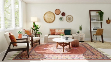 Sala acogedora con tapete grande, cojines y decoración cálida que transforma un departamento rentado en un espacio personal.